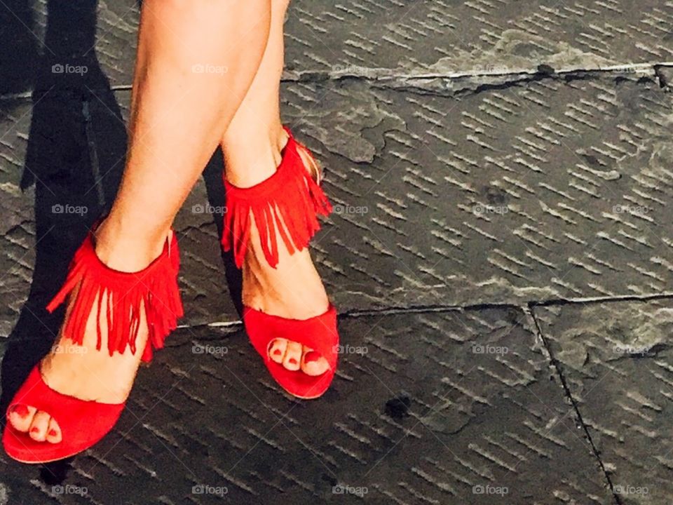 Woman wearing red shoes