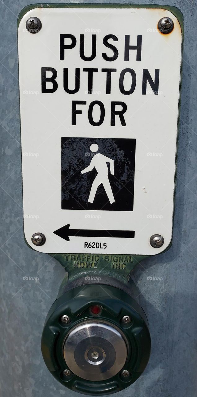 Round push button for walking through the crosswalk on a city street