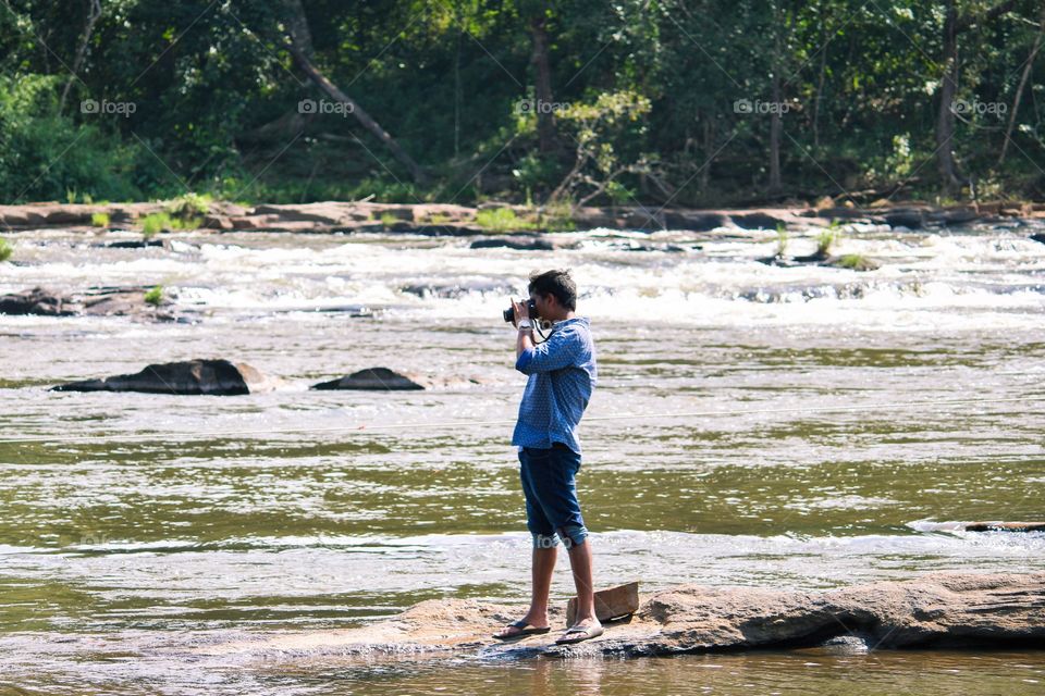 man capturing the waterfalls