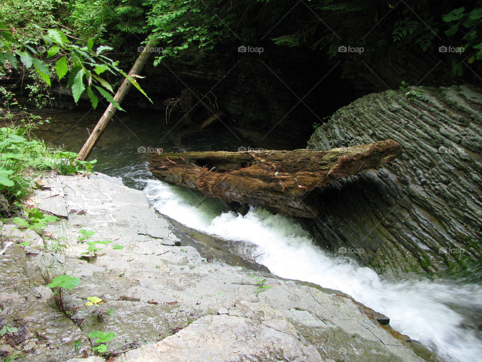 Waterfall in Carpathian mountains with a wooden brick  