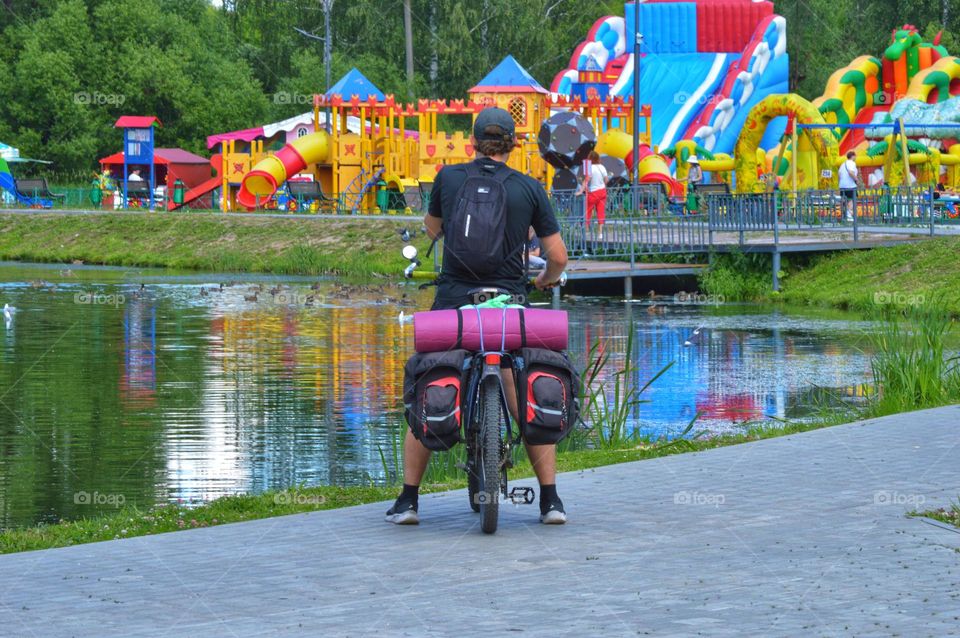 cyclist traveler stopped in the park near the water