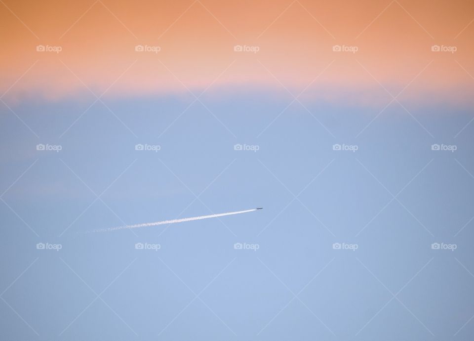 Plane in a sky at sunset
