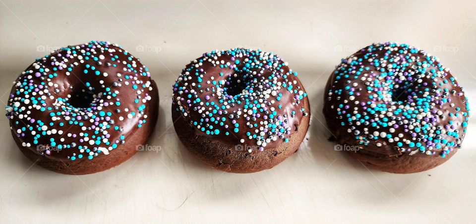 Geometry series: Circles. Homemade chocolate donuts with sprinkles.