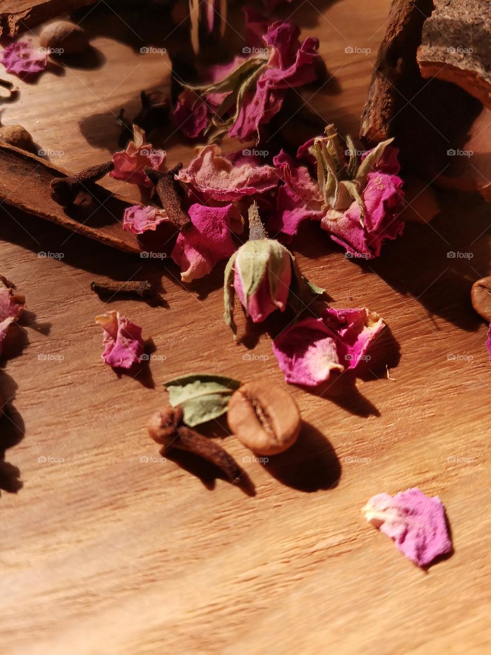 coffee cinnamon and roses on a wooden background