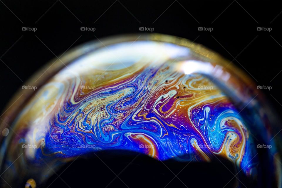 Abstract multicolored pattern inside of the soap bubble, closeup