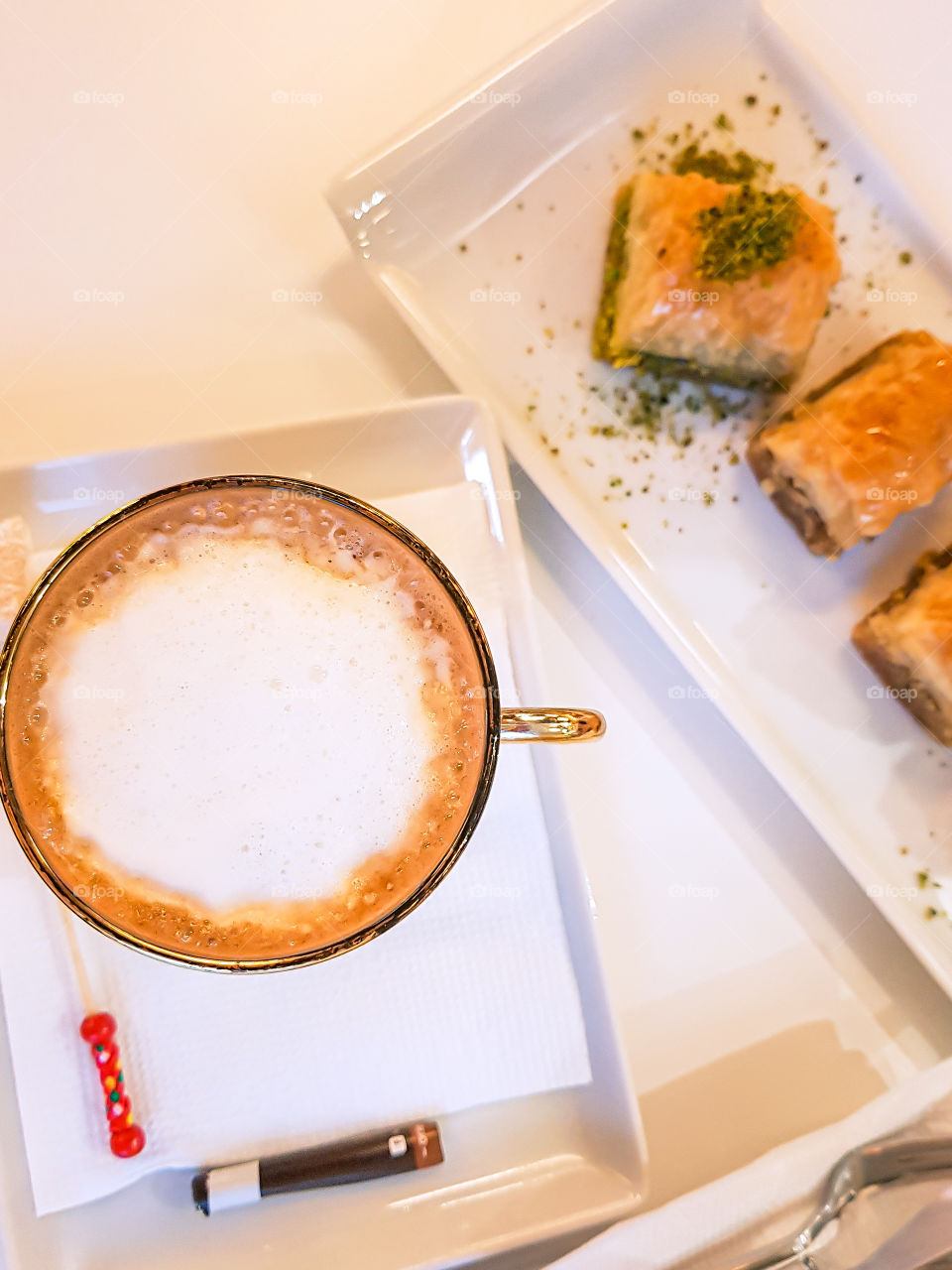 Top view of cup with coffee and some pastry.