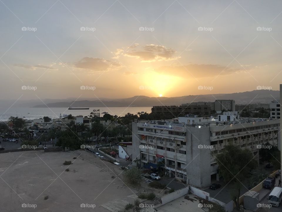 Sunset over the arabic town and the red sea
