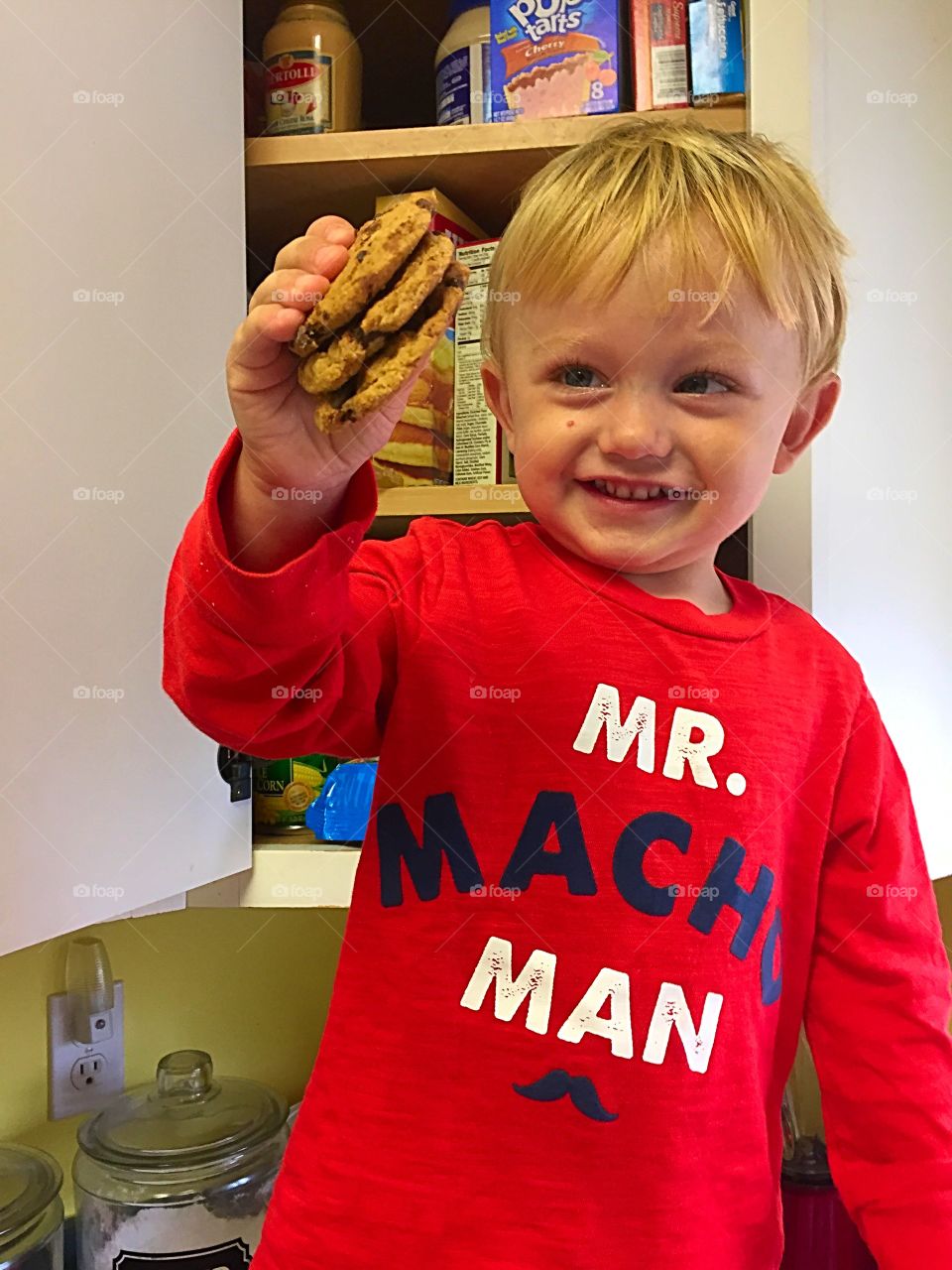 Small kid holding cookies in hand