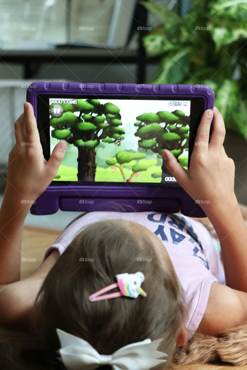 Child playing on her tablet