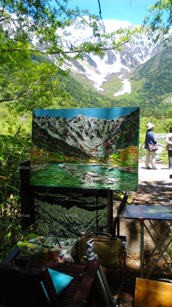 Local artist working on a painting of the gorgeous mountains of Kamikochi