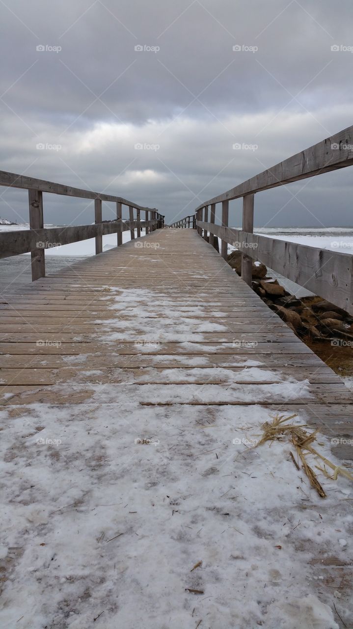 a winter walk. view of the beach fron the foot bridge