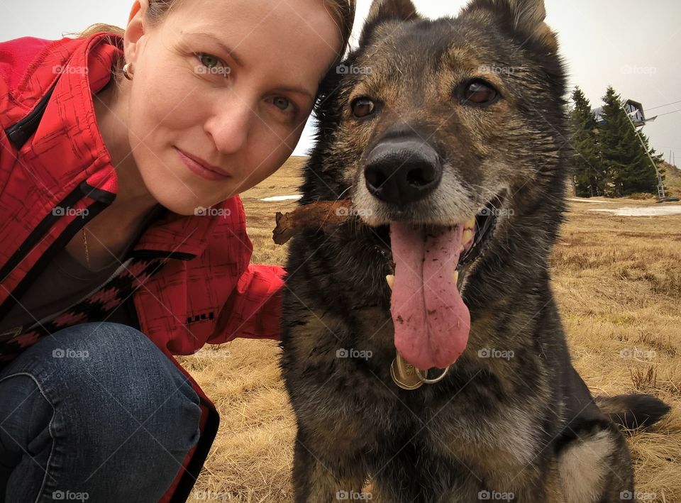 A girl with German Shepherd dog on the walk in nature. Slovakia
