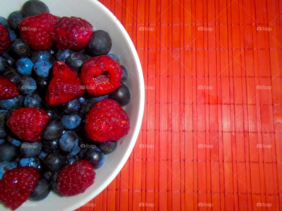 Raspberries and blueberries bowl