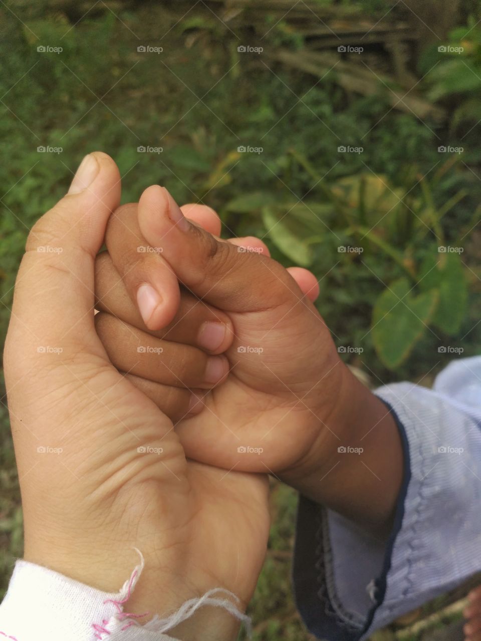 Mother and boy hand