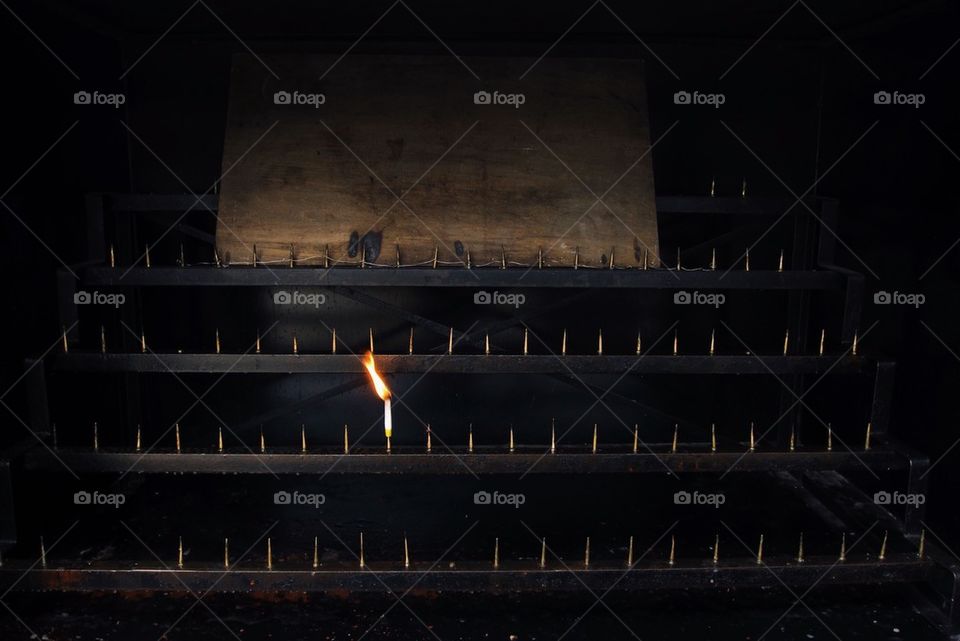 A single incense burning in an altar