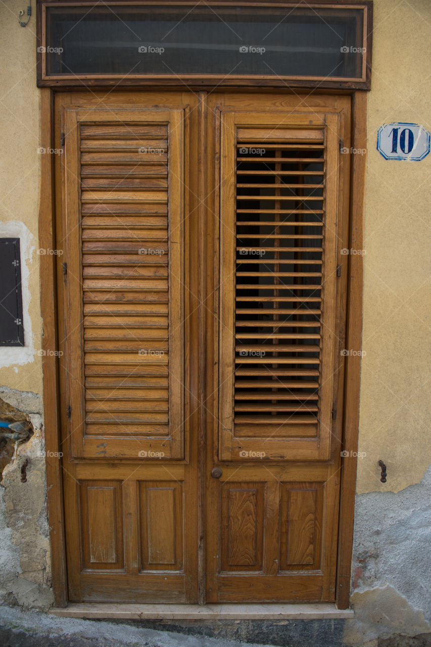 Old door in the city of Cefalu on Sicily.