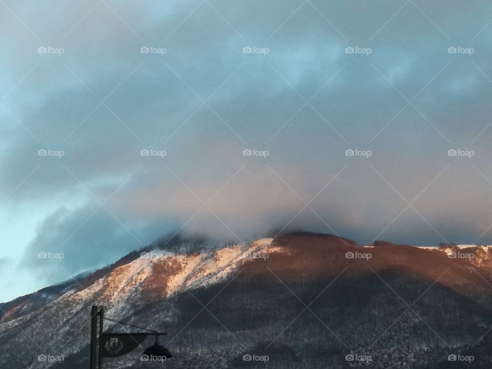 Sunset colours the back mountain