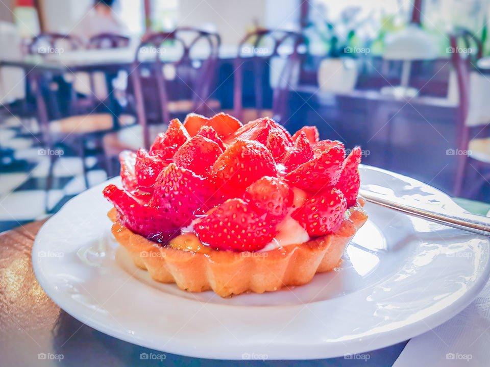 Delicious tart with vanilla cream and strawberries is perfect dessert for sweet summer day.