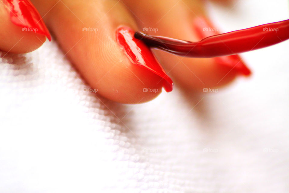 Red nail painted during manicure at beauty saloon . A lady thing for those who care