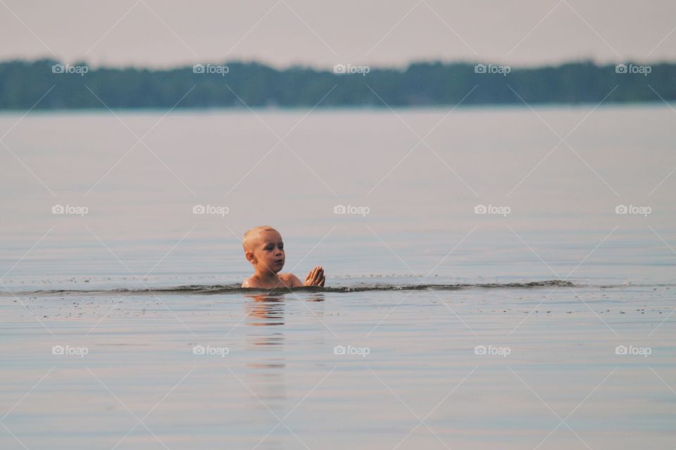 Boy swimming in the lake