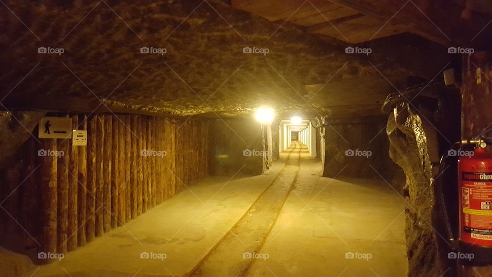 A corridor in a mine with a rail track running through