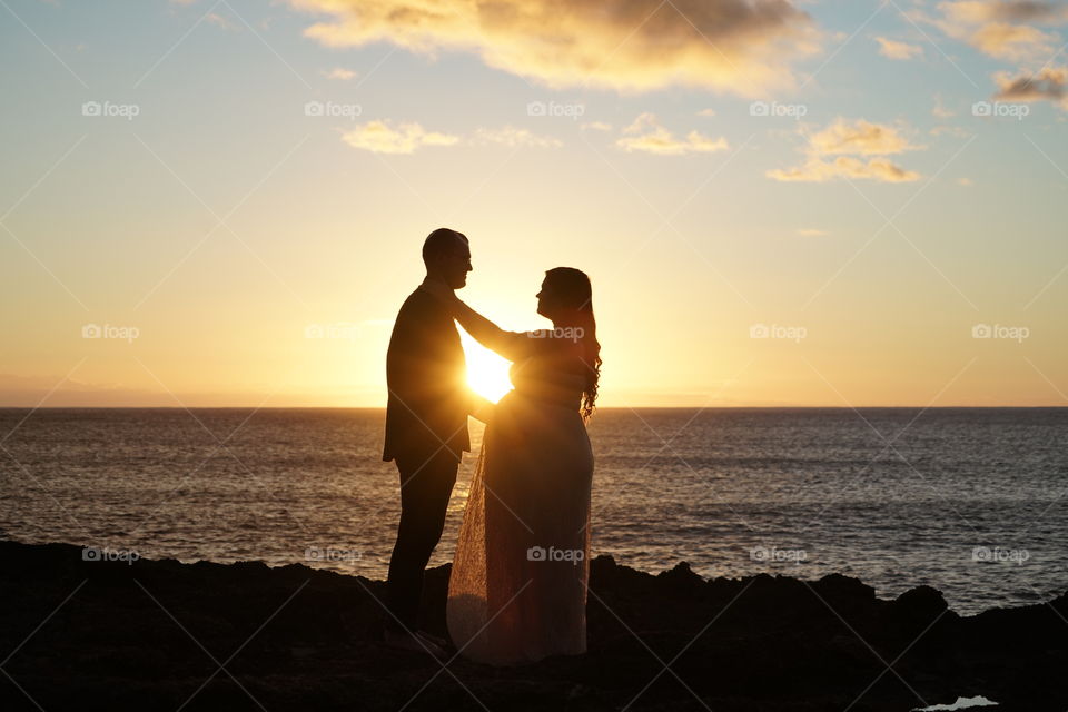 Beautiful couple loving on each other during a summer sunset 