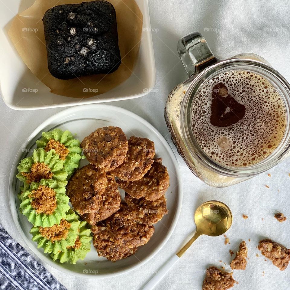Afternoon snacks ondeh cookies and chocolate chip oat cookies with black brownie and sea salt and ice cold black coffee