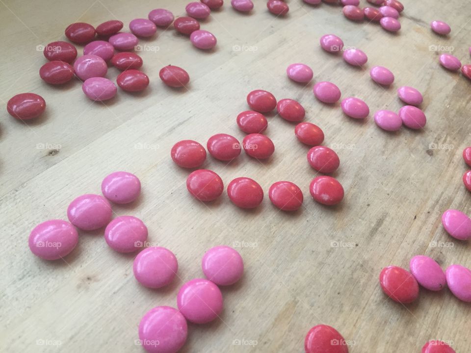 Valentine's Day pink and red valentines candies that say I love you and XoX