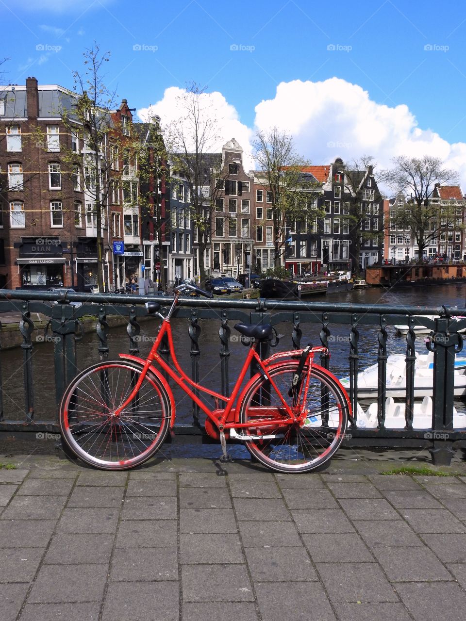 Red bike by a canal in Amsterdam 