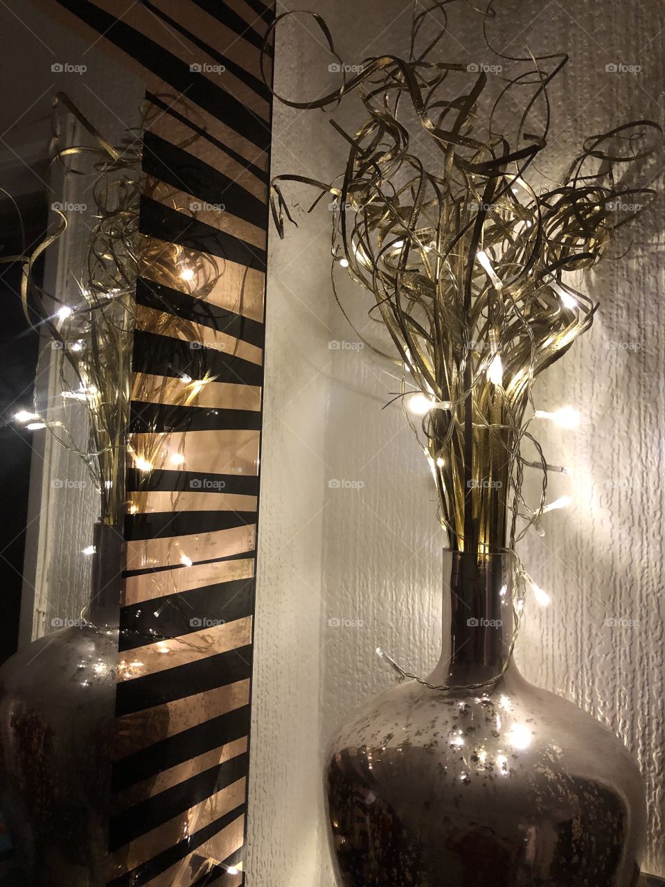 Fairy lights and vase reflecting in the mirror 