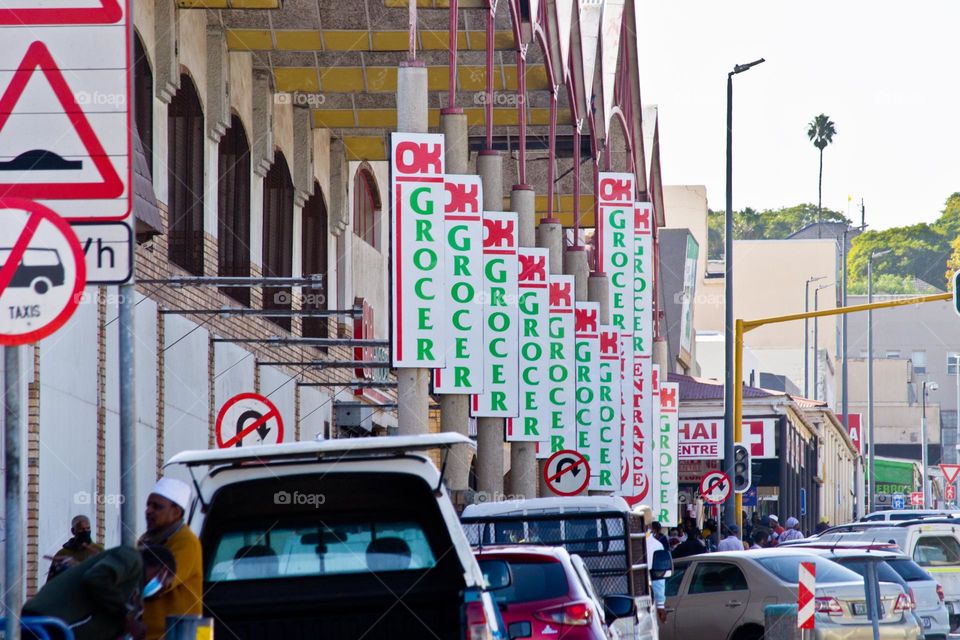 Multiple Ok grocer advertising poster boards