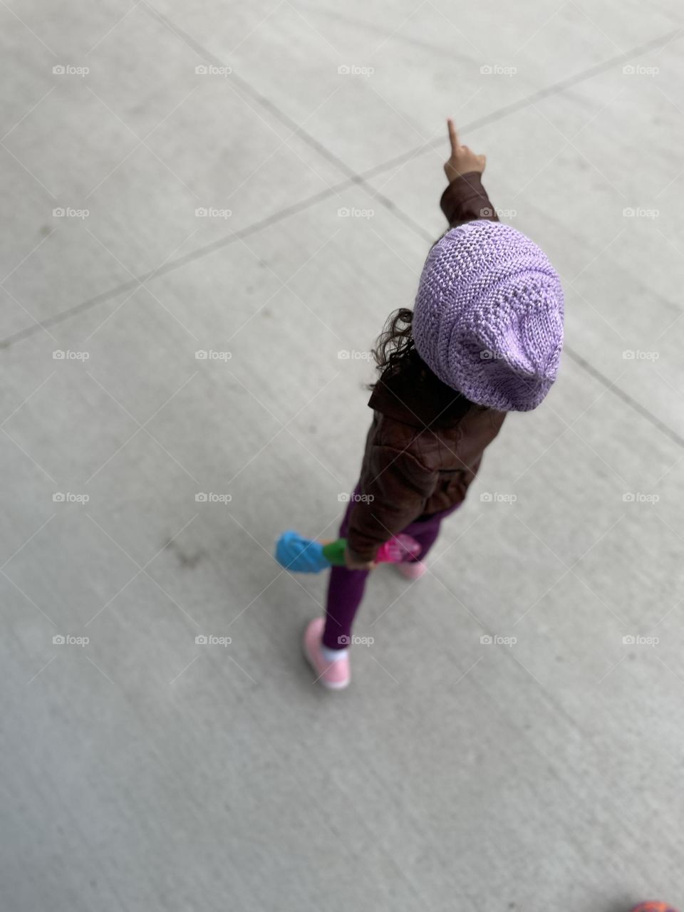 Toddler girl walking and pointing, toddler is excited to lead the way, born leader, toddler leads the way for Mommy, toddler helps Mommy