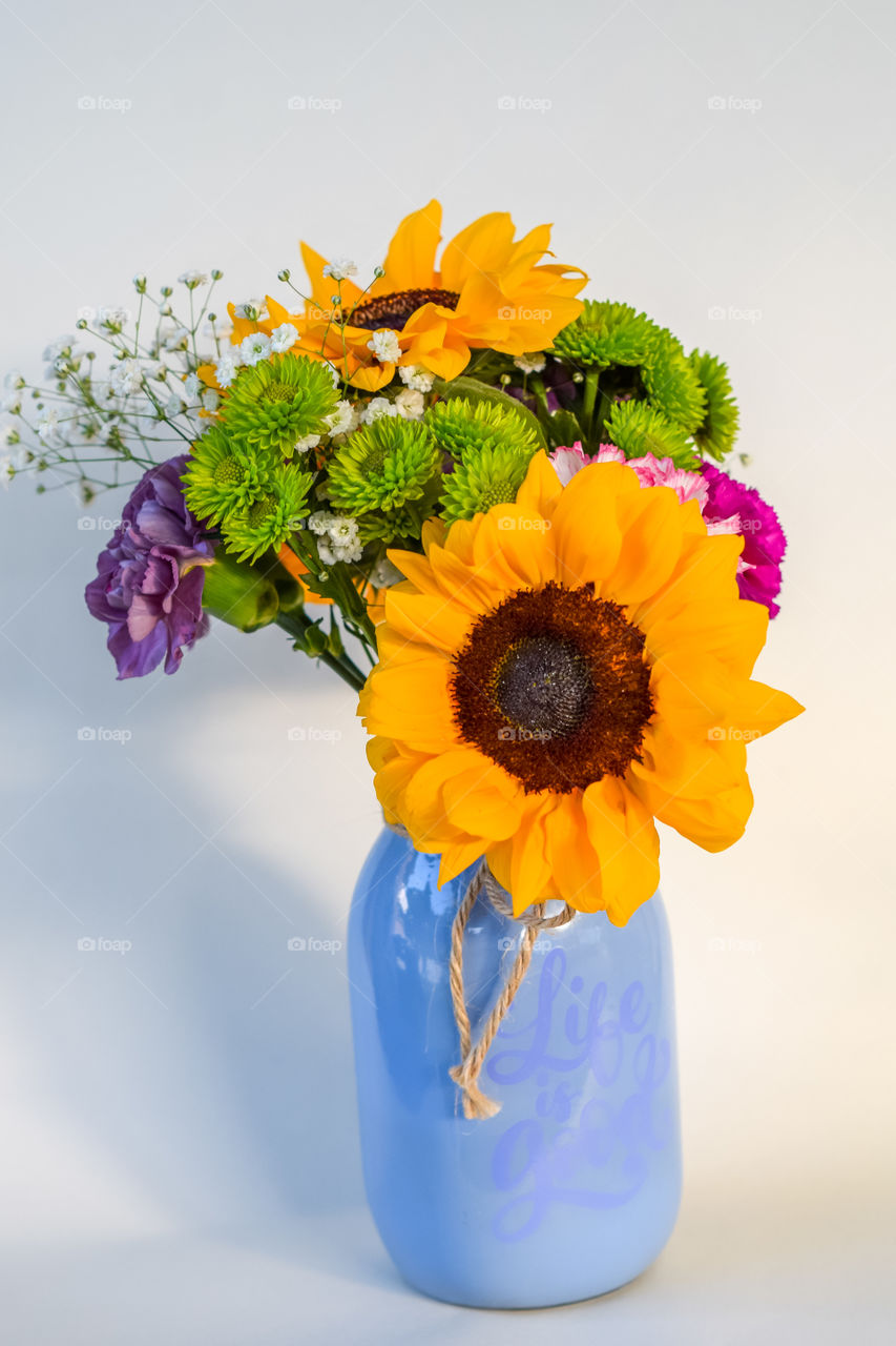 sunflowers in purple vase