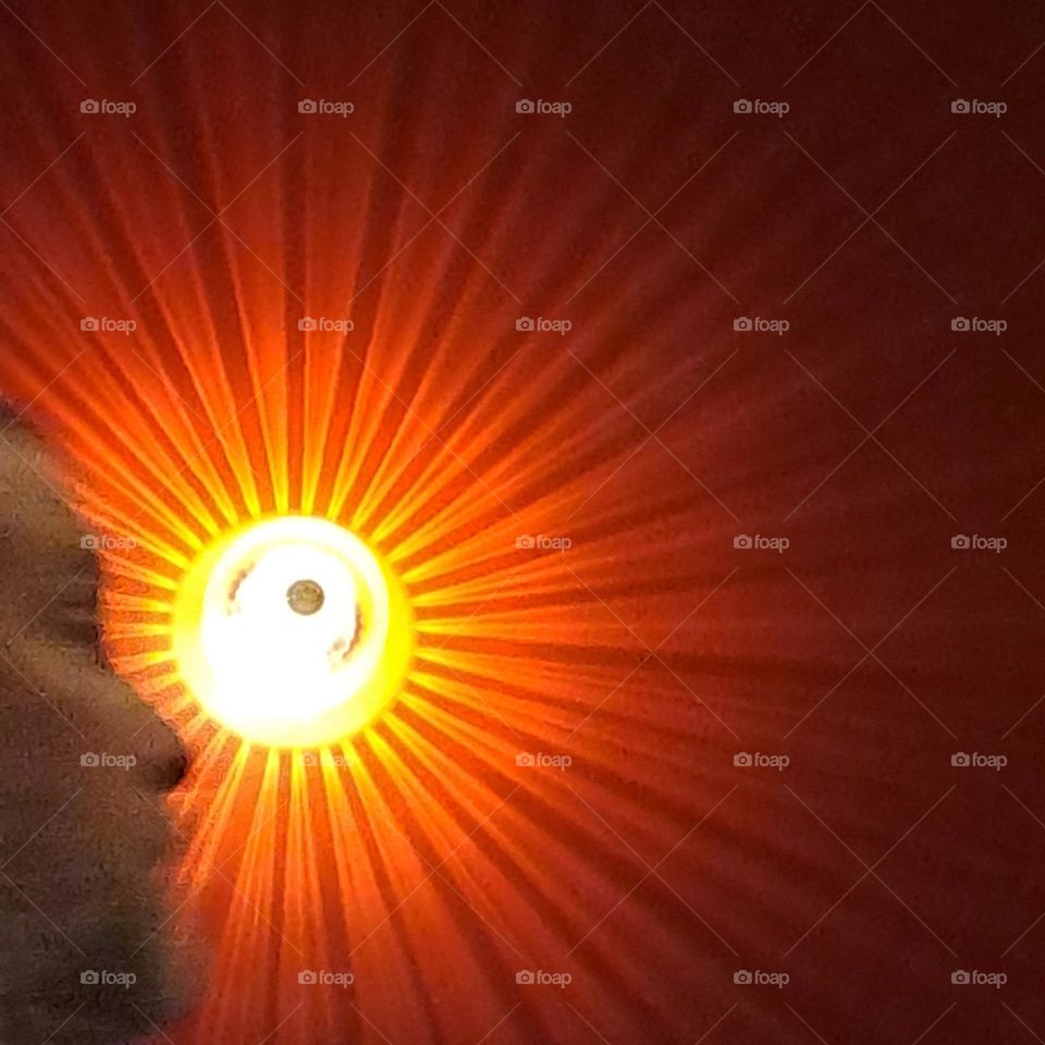 wall light with rays like sunshine in red orange yellow. Autumn/Fall colours