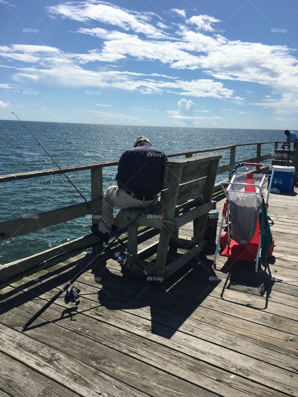 This old fisherman knew exactly what he was doing as he slowly and steadily baited the hooks, threw out the line, reeled in the fish, and unhooked them. I'm guessing he's been at this for years.