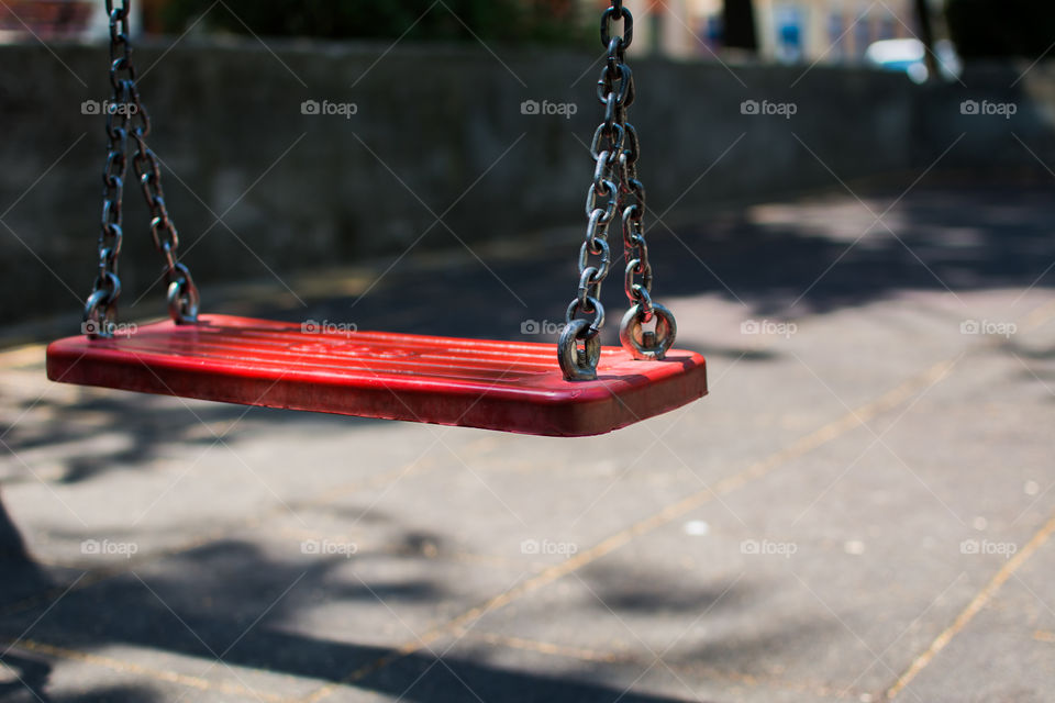Close-up of red swing