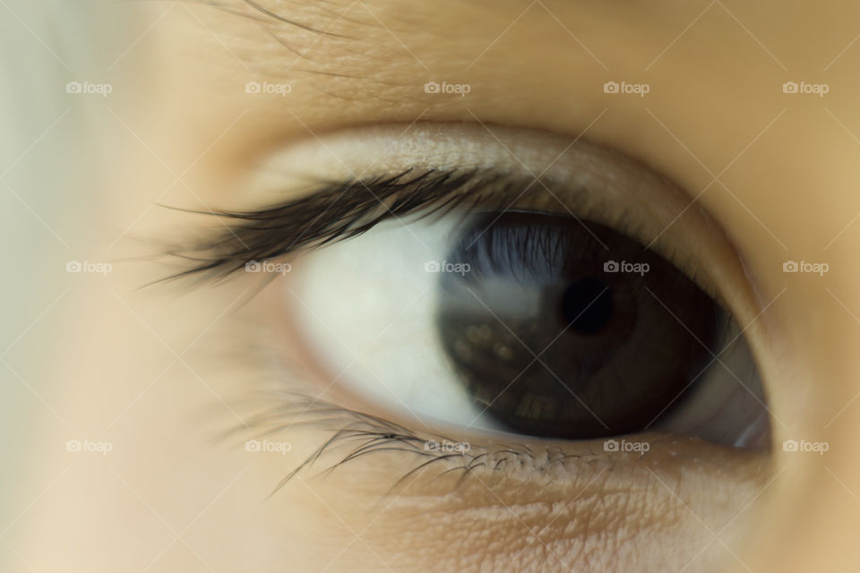 Macro close eyes of Asian kid's. Natural deep dark color iris.