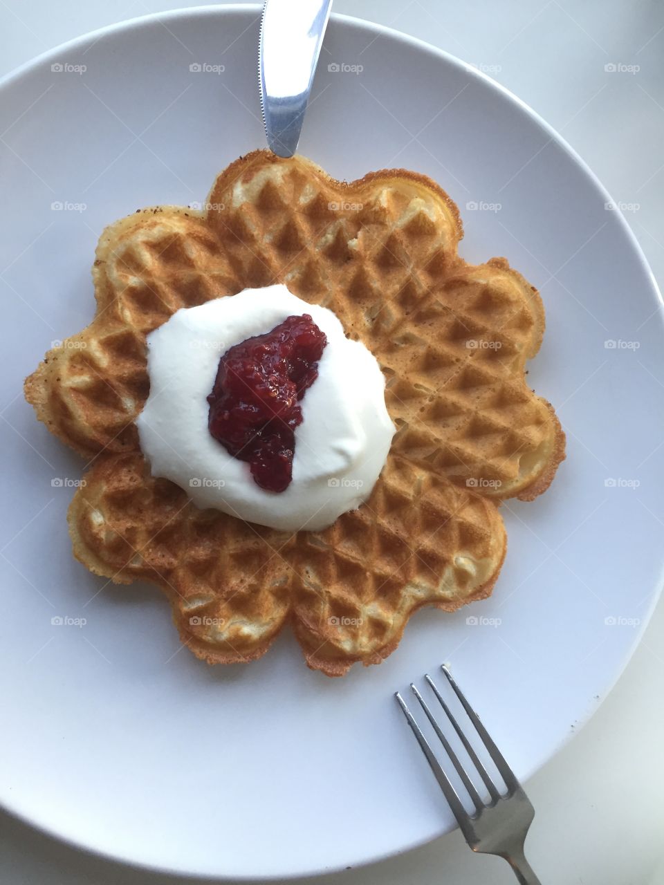 Waffle with cream and jam above 