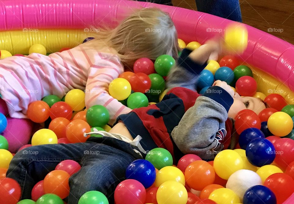 Children playing in a ball pit