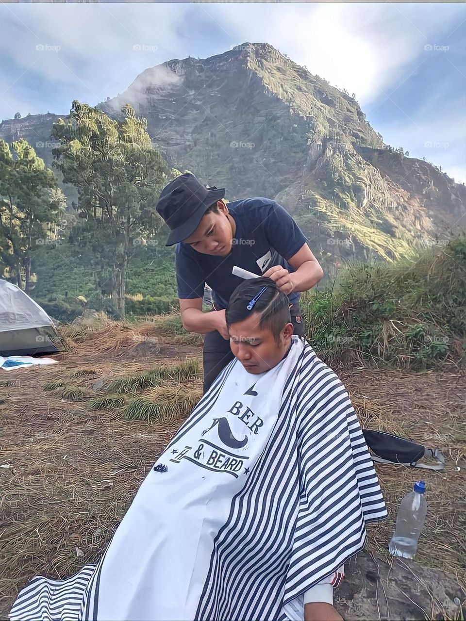 Giving Client the Best Haircut on the Top of Mountain Barbershop