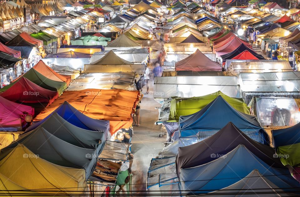 Colorful night Color life of Crowed tourists take their happiness hour to shopping at Beautiful night flea market in Bangkok Thailand 