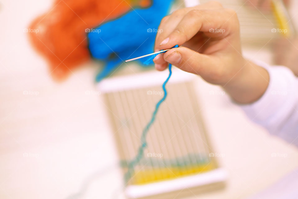 Children weaving loom at home