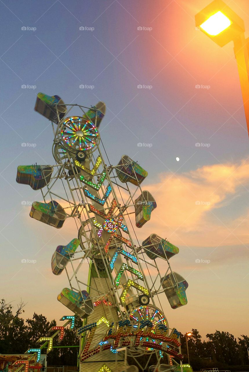 zipper ride at a fair or festival during sunset, fairgrounds