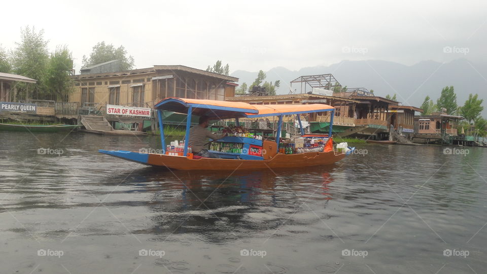 A beautiful "Shikara' having shoping facility on board being rowed near House boats in Dal lake Srinagar ( in Kashmir Valley) near Dalgate Srinagar kashmir..