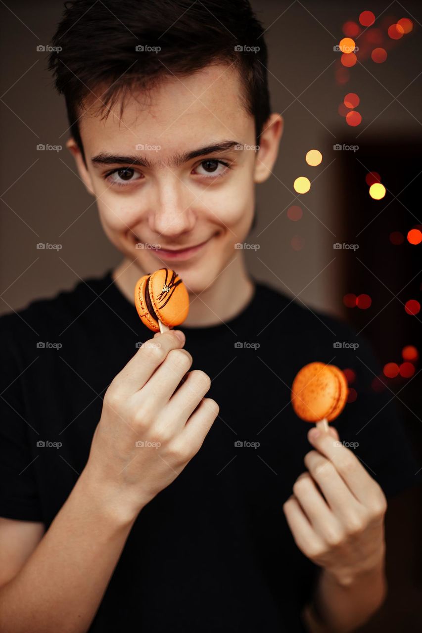 Person with orange macarons.