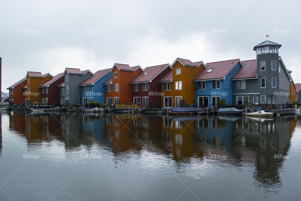 Colorful houses reflecting on water