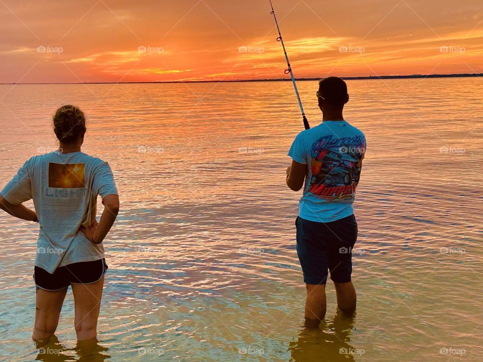 A couple fish during sunset. Sunsets bring with itself, such orangish colors in the sky which are beautiful to stare at. 