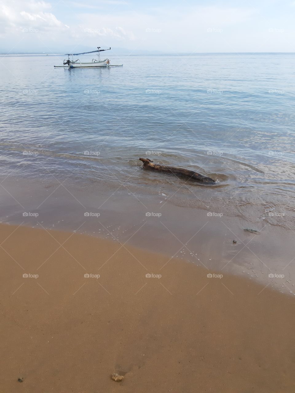 An old trunk and a fishing boat on the water