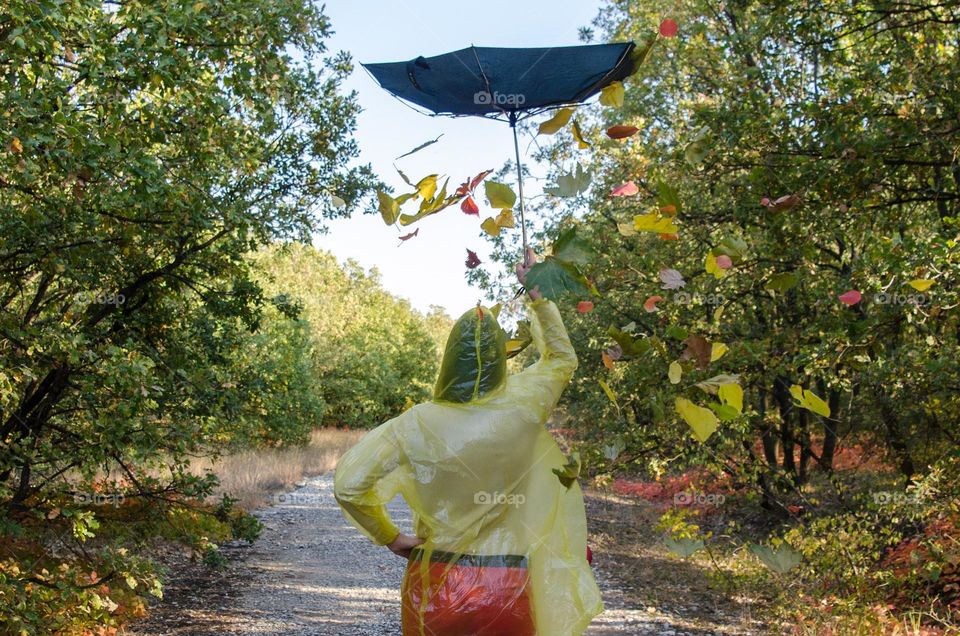 Young Girl with Umbrella on the autumn background