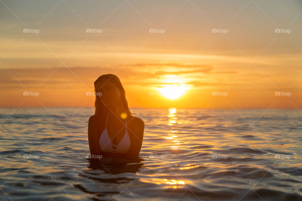 Beautiful young woman in bikini on the sea 